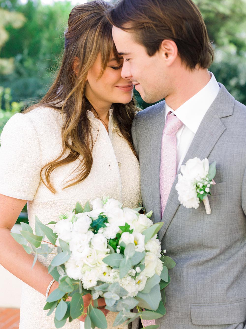 they kiss, she holds the flower bouquet